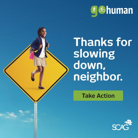 Child walking on pedestrian sign against blue sky background.